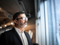 Mature businessman looking out of window