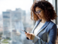 Young businesswoman using smart phone in office. 