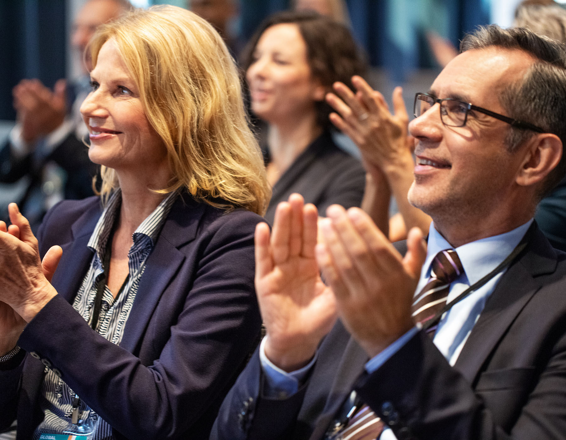 Crowd of business professionals applauding keynote