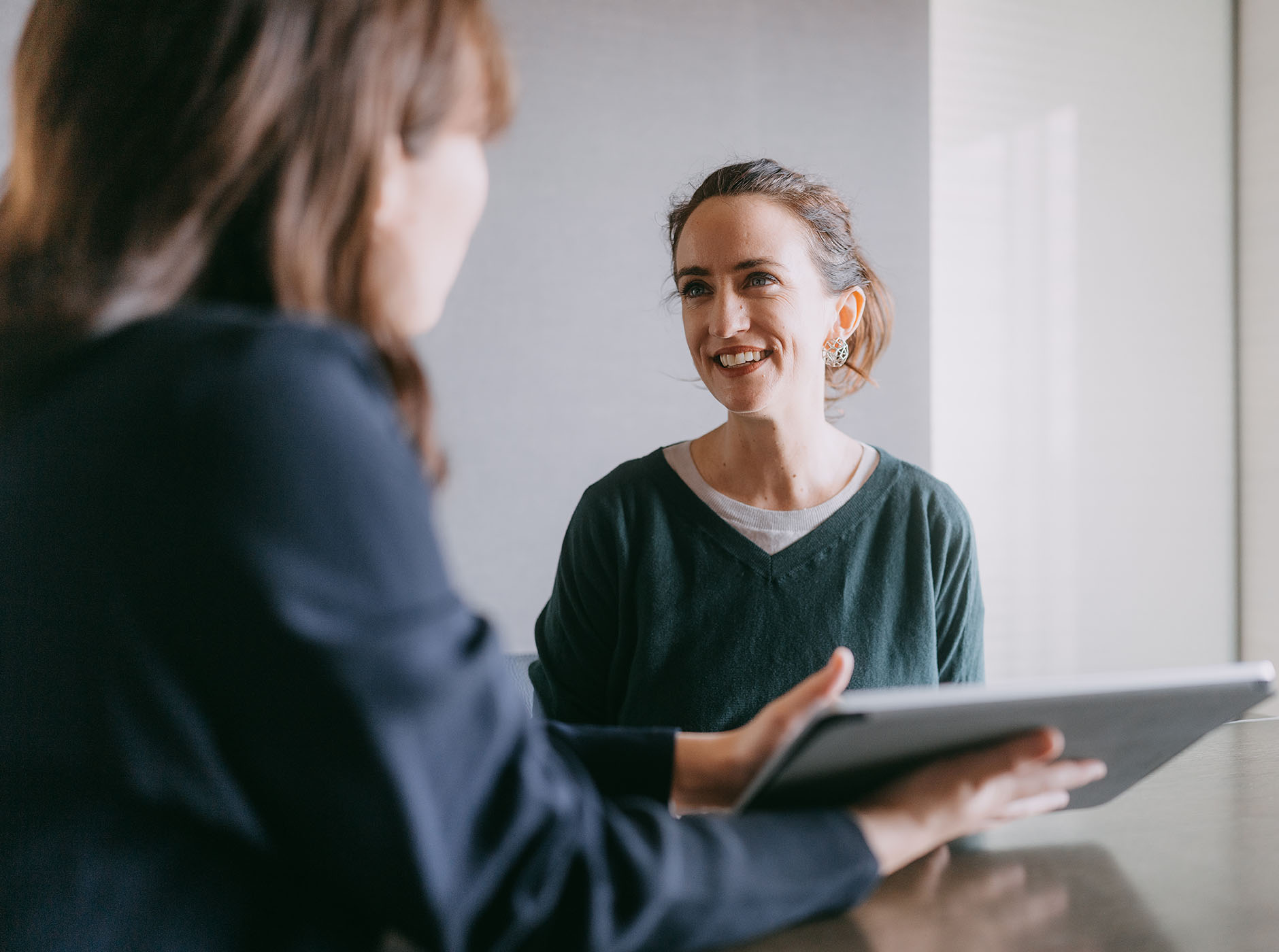 young casually dressed woman meeting with colleague in a meeting room