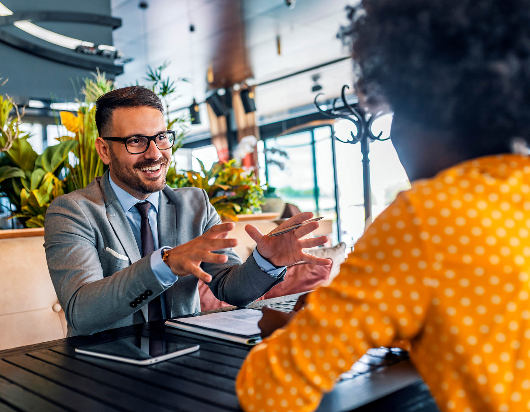 young business man and woman meeting in cafe setting talking