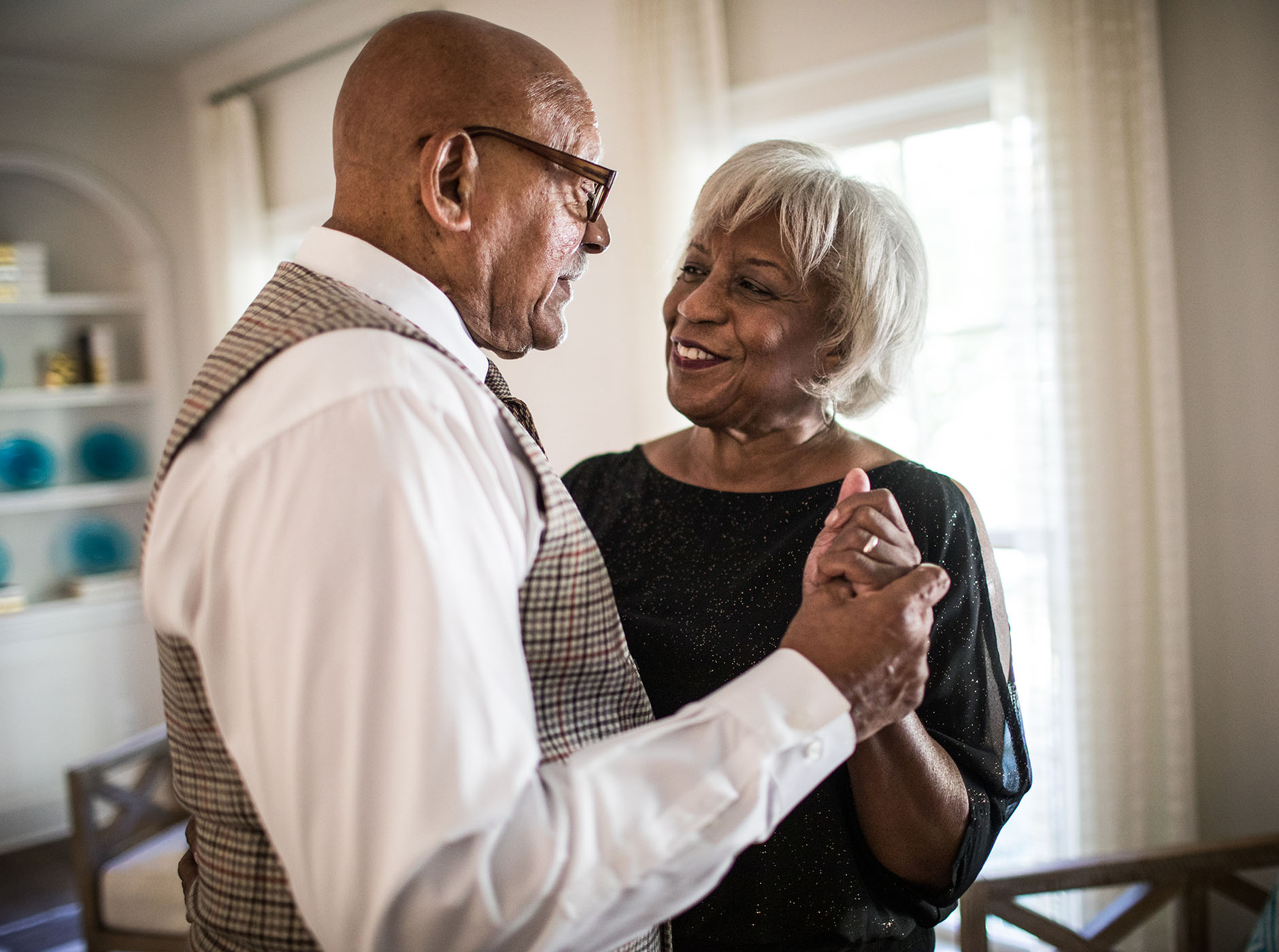 smiling diverse senior couple dancing together