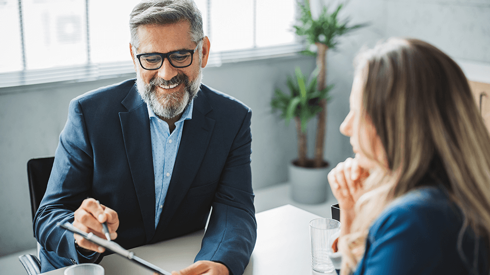 Gentleman wearing glasses smiling hero image