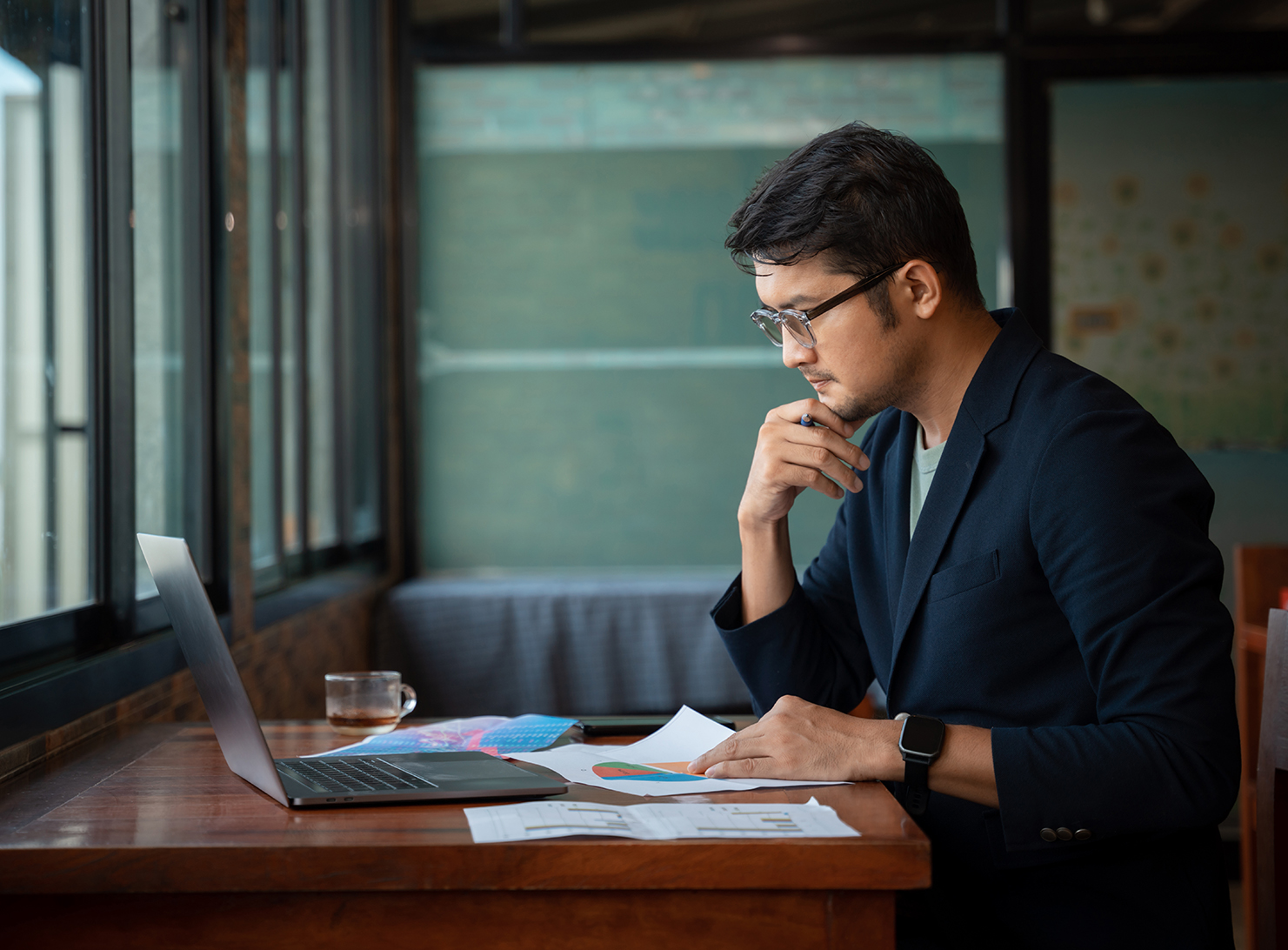 office worker studying information on a laptop