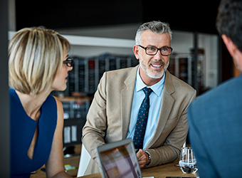 three people in a business meeting close together